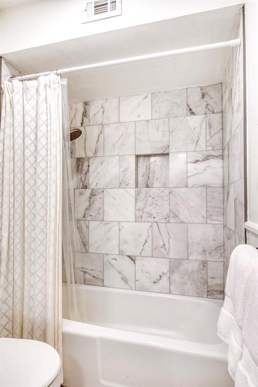 4829 Harvest Hill Dallas, TX 75244 - Photo 19 of 35 a bathroom with a bathtub and shower