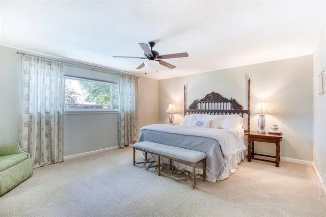 a spacious bedroom with a bed and window