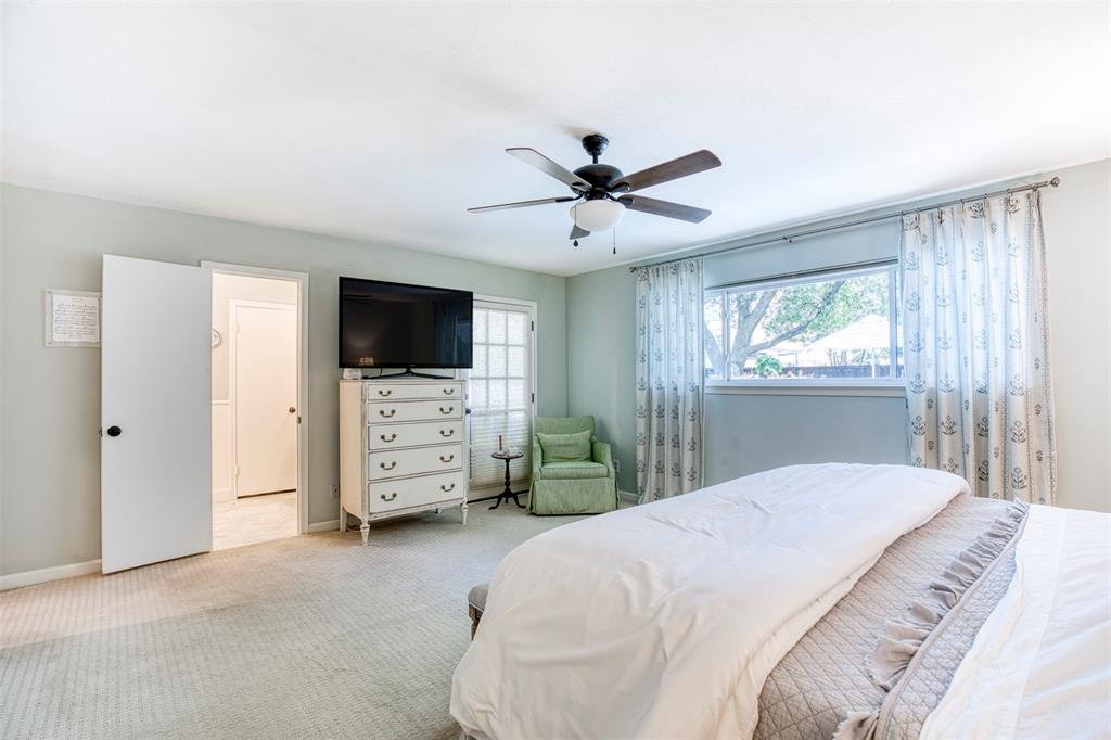 4829 Harvest Hill Dallas, TX 75244 - Photo 22 of 35 a bedroom with a bed and a flat tv screen on the dresser