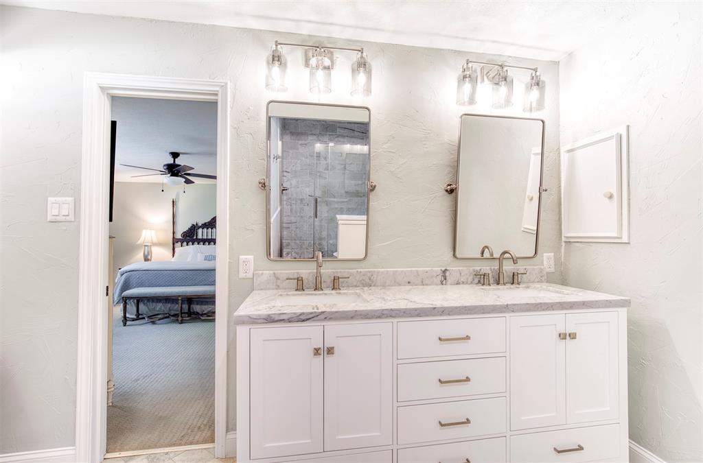 4829 Harvest Hill Dallas, TX 75244 - Photo 25 of 35 a en suite bathroom with a granite countertop sink and a mirror