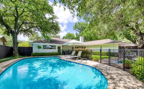 a view of a house with a yard patio and a garden