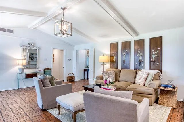 a living room with furniture wooden floor and a chandelier