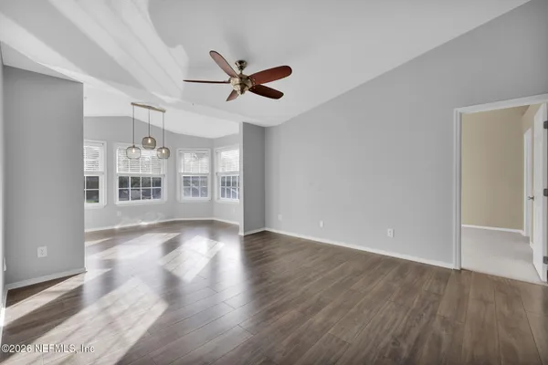 wooden floor in an empty room with a window