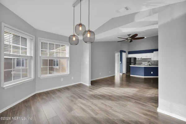 a view of kitchen with cabinets and wooden floor