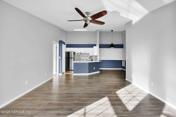a view of kitchen with cabinets and wooden floor