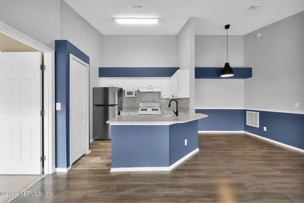 a kitchen with a refrigerator and a sink