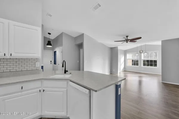 an empty room with windows and closet