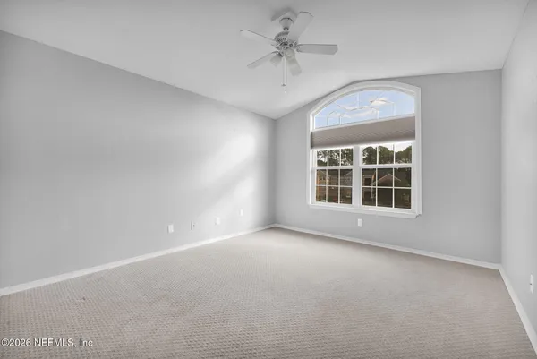 a bedroom with bed and a window