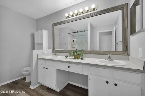 a bathroom with a shower and a sink