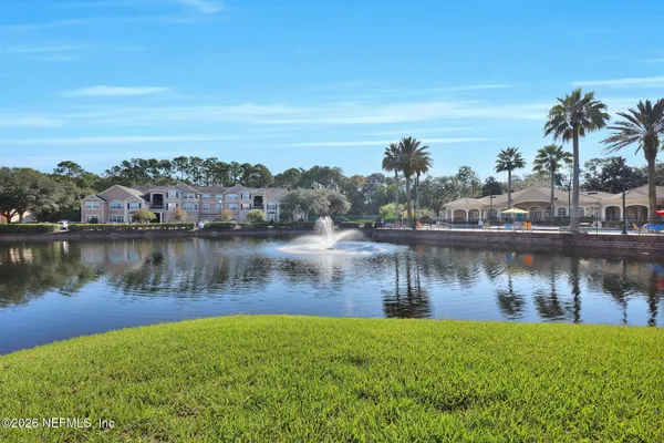 a view of a lake with houses in the back