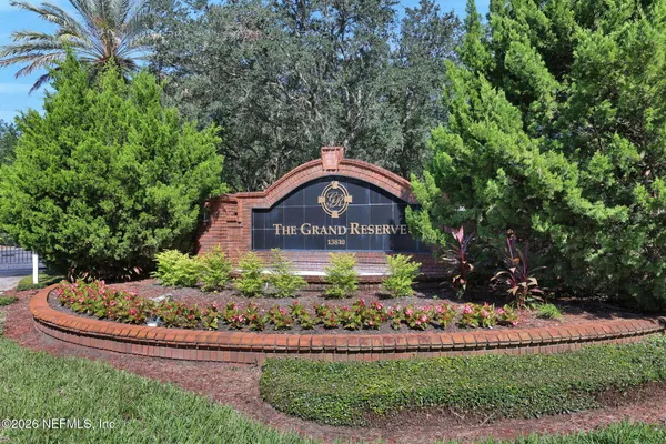 a front view of a house with yard and green space