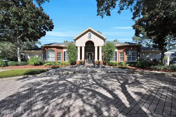 a living room with fireplace furniture and a large window