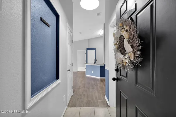 a view of an empty room with wooden floor