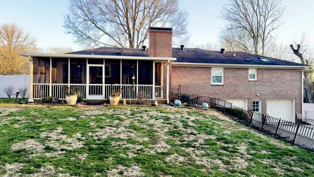 a house with lots of trees in the background