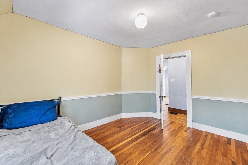 4 State Street, Unit 4 Milford, MA 01757 - Photo 15 of 23 a bedroom with a bed and wooden floor