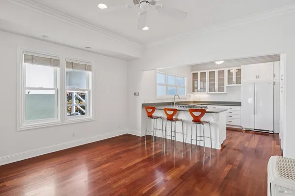 a kitchen with granite countertop white cabinets and sink