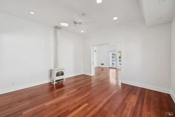 a kitchen with a stove and a wooden floor