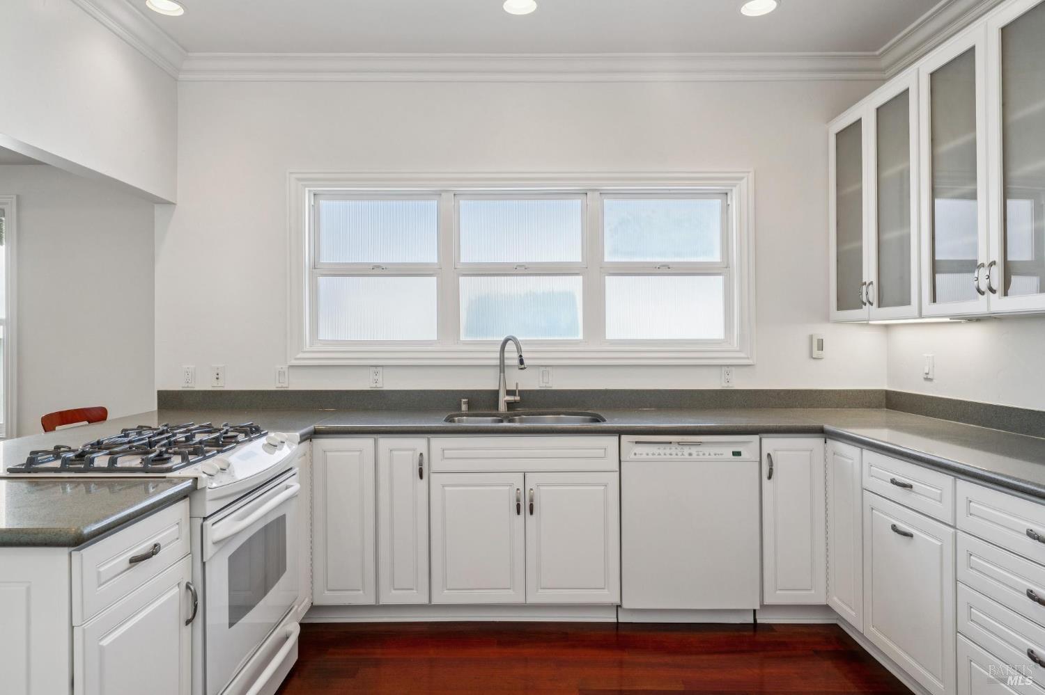 102 F Street San Rafael, CA 94901 - Photo 19 of 80 a kitchen with granite countertop white cabinets and sink