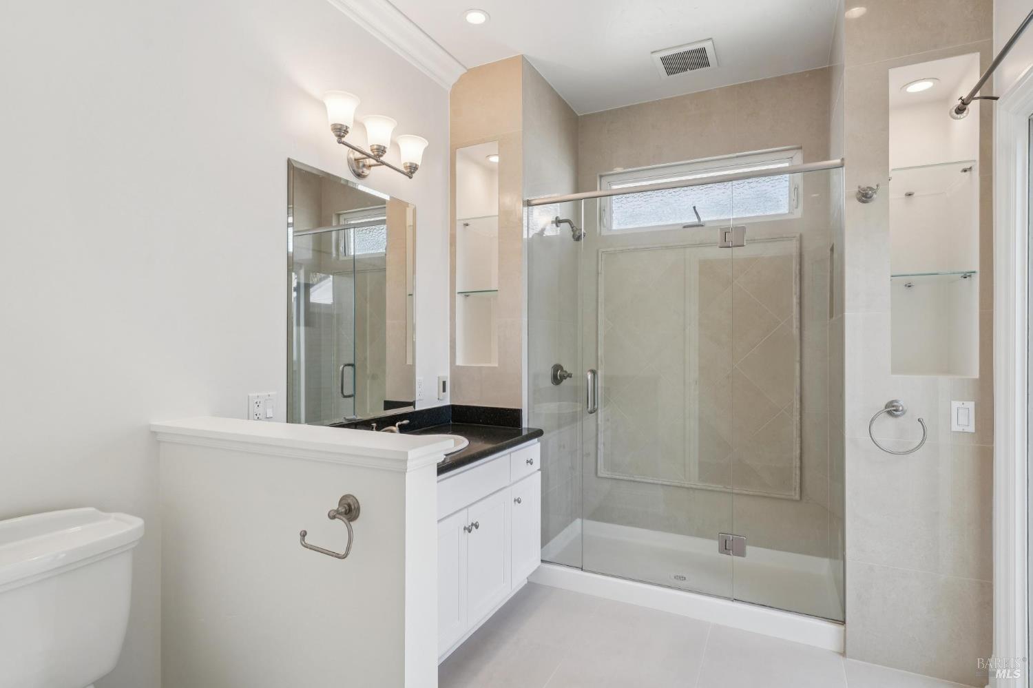 102 F Street San Rafael, CA 94901 - Photo 30 of 80 a bathroom with a granite countertop sink a mirror a shower and a mirror