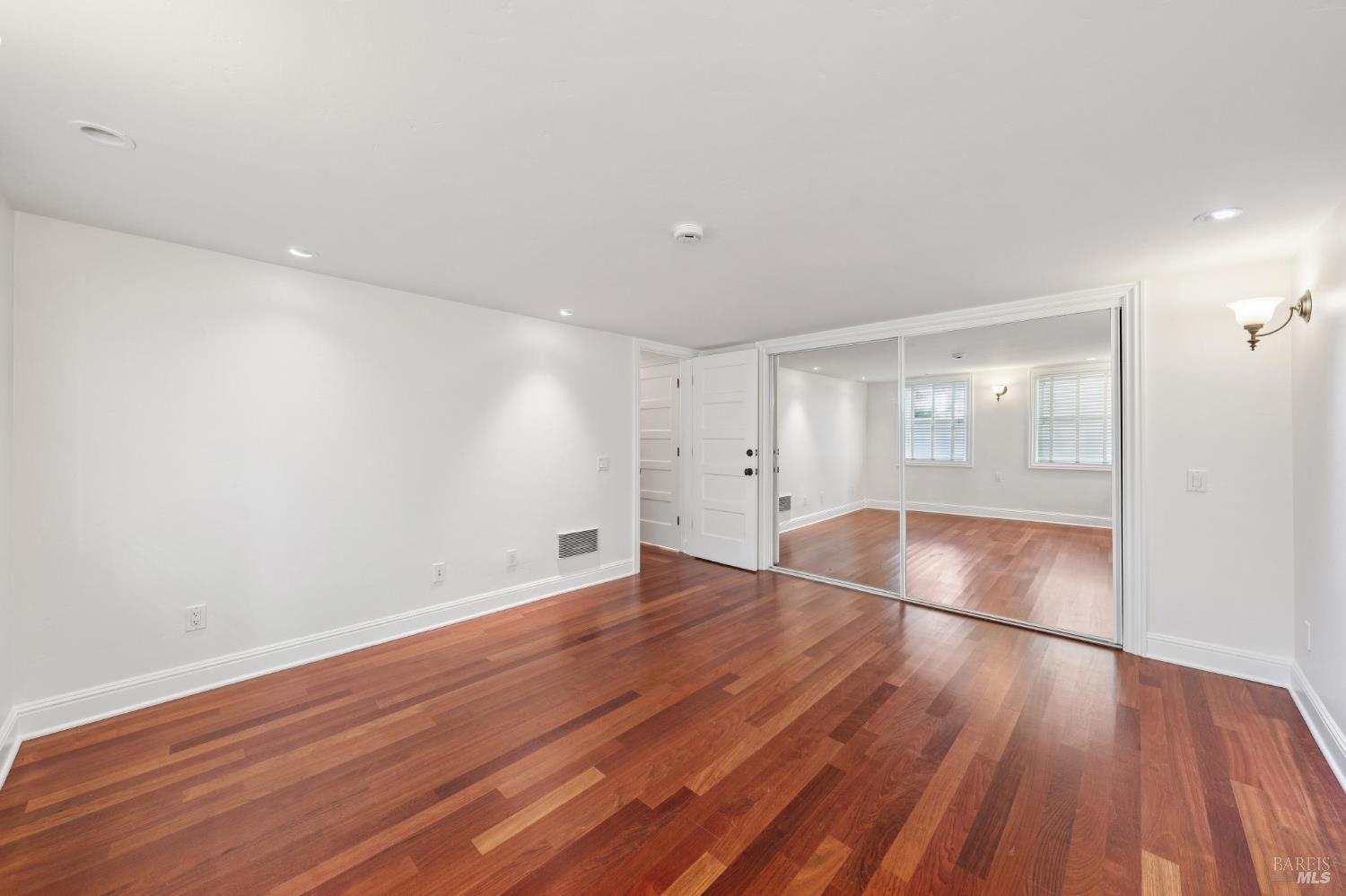 102 F Street San Rafael, CA 94901 - Photo 38 of 80 an empty room with wooden floor and windows