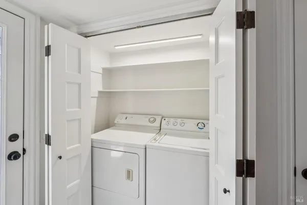 a kitchen with a table chairs refrigerator and window