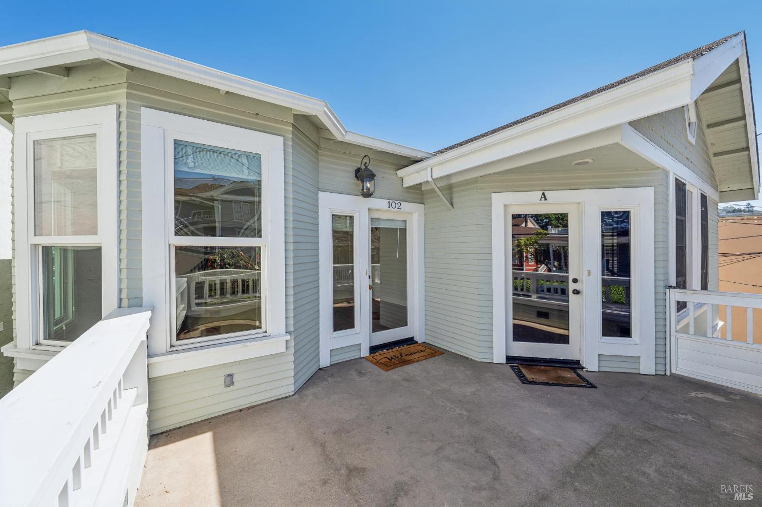 102 F Street San Rafael, CA 94901 - Photo 4 of 80 a view of an empty room with wooden floor and windows