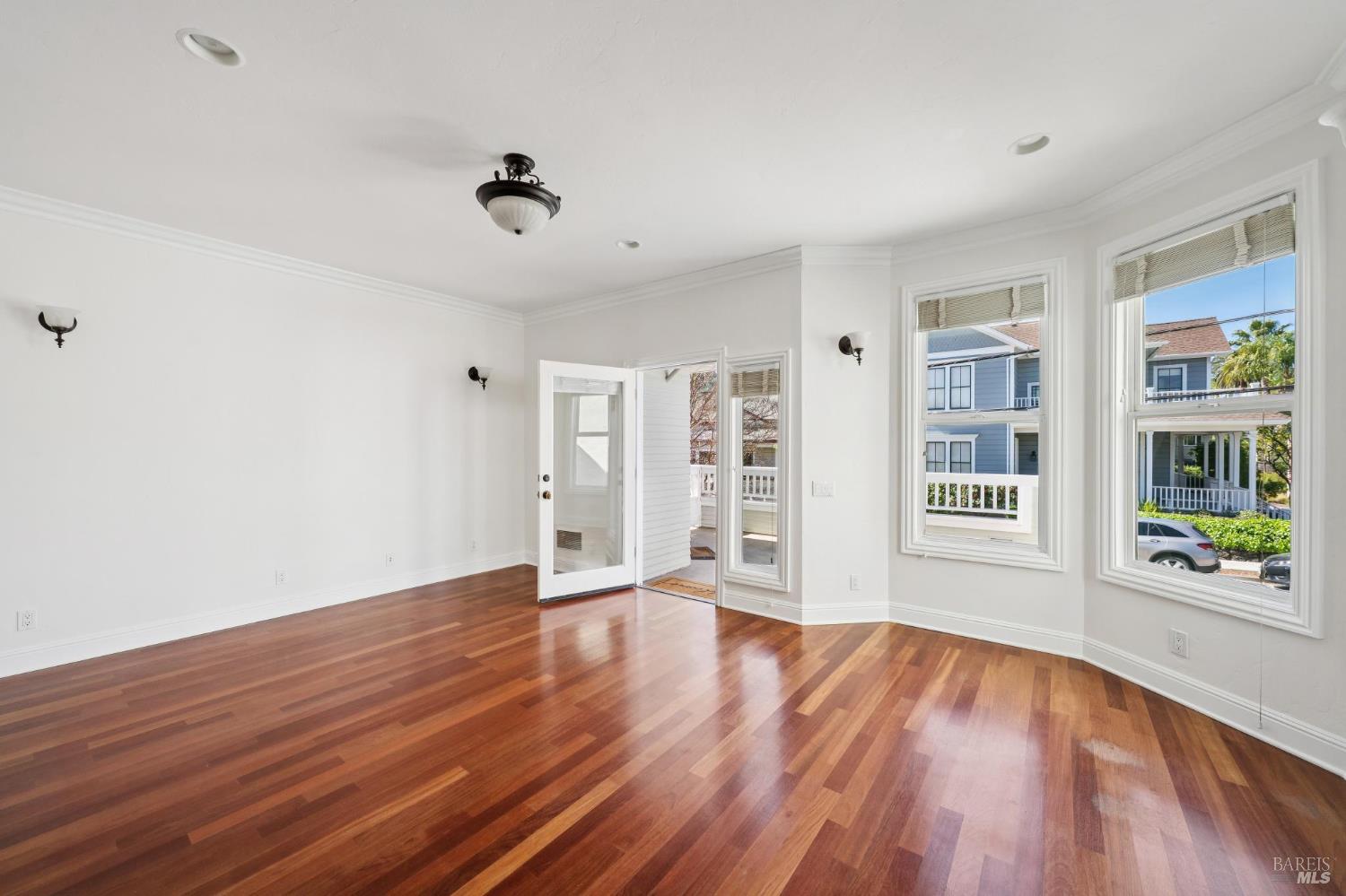 102 F Street San Rafael, CA 94901 - Photo 5 of 80 a view of an empty room with wooden floor and a window