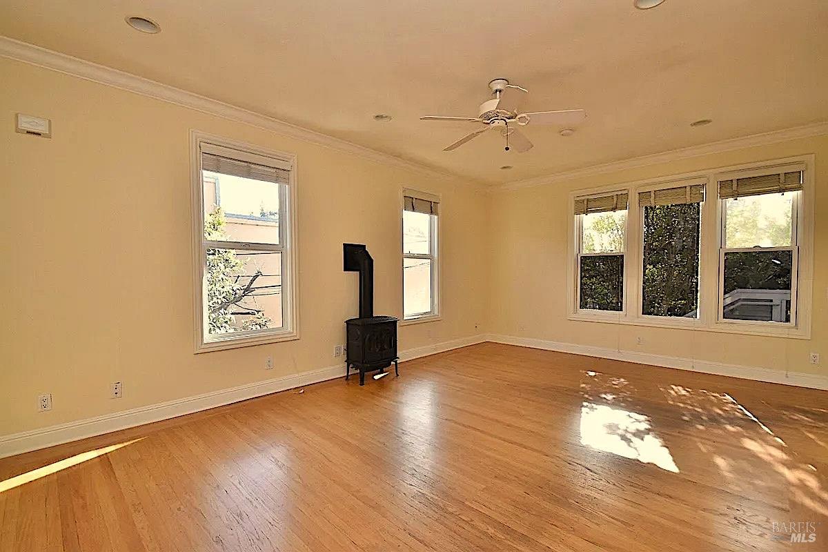 102 F Street San Rafael, CA 94901 - Photo 58 of 80 a view of an empty room with a window and wooden floor