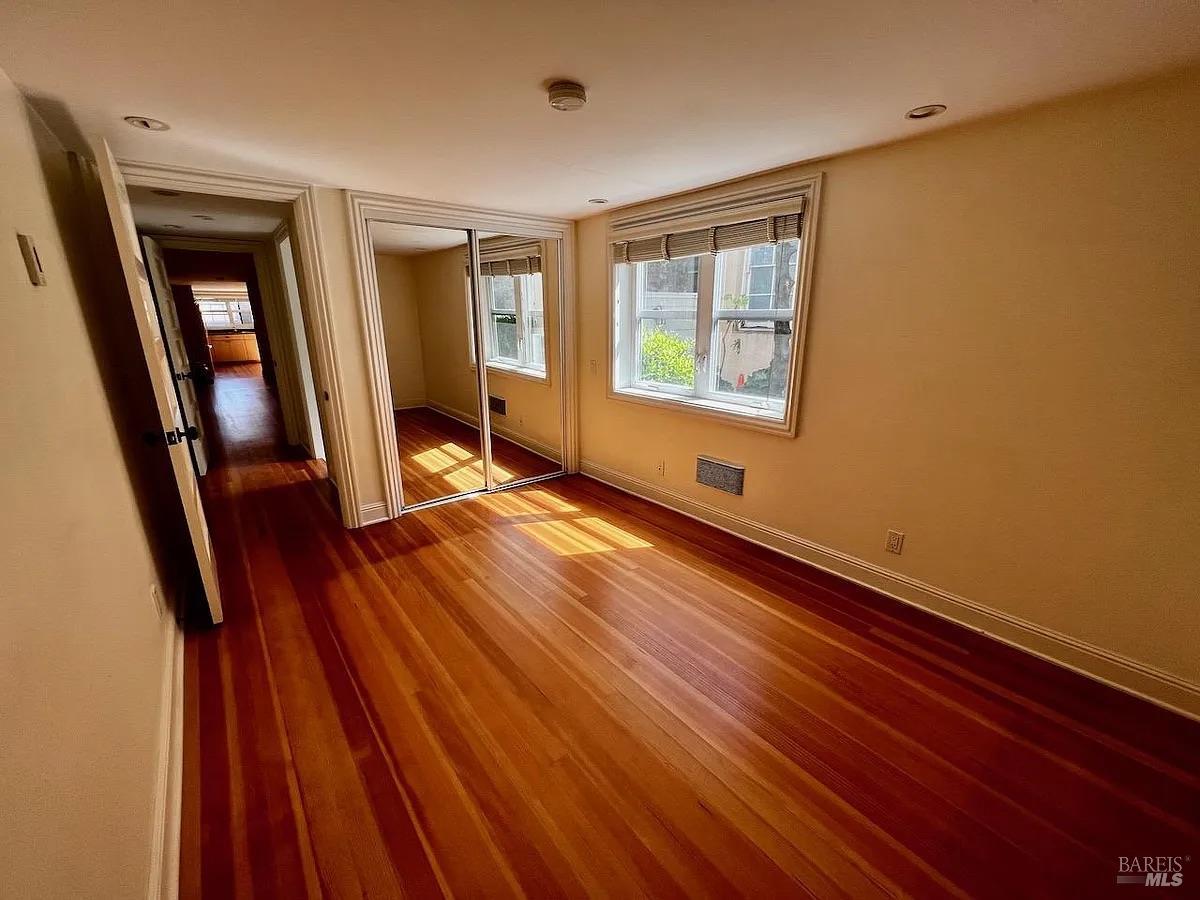 102 F Street San Rafael, CA 94901 - Photo 73 of 80 a view of an empty room with wooden floor and a window