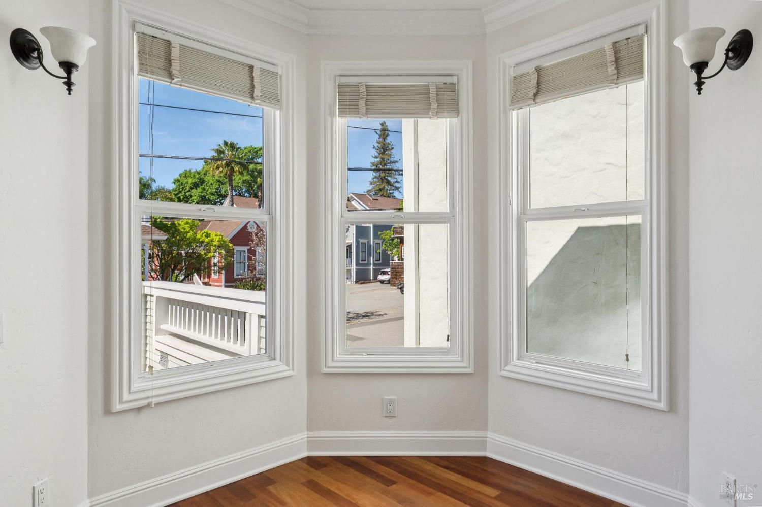 102 F Street San Rafael, CA 94901 - Photo 9 of 80 a view of an empty room with wooden floor and a window