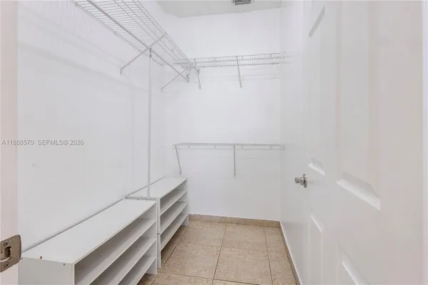 a kitchen with a refrigerator and a stove top oven