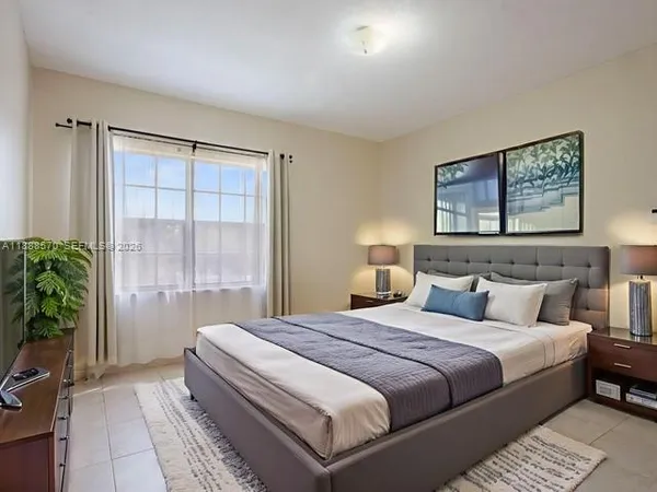 a bedroom with a bed and a potted plant
