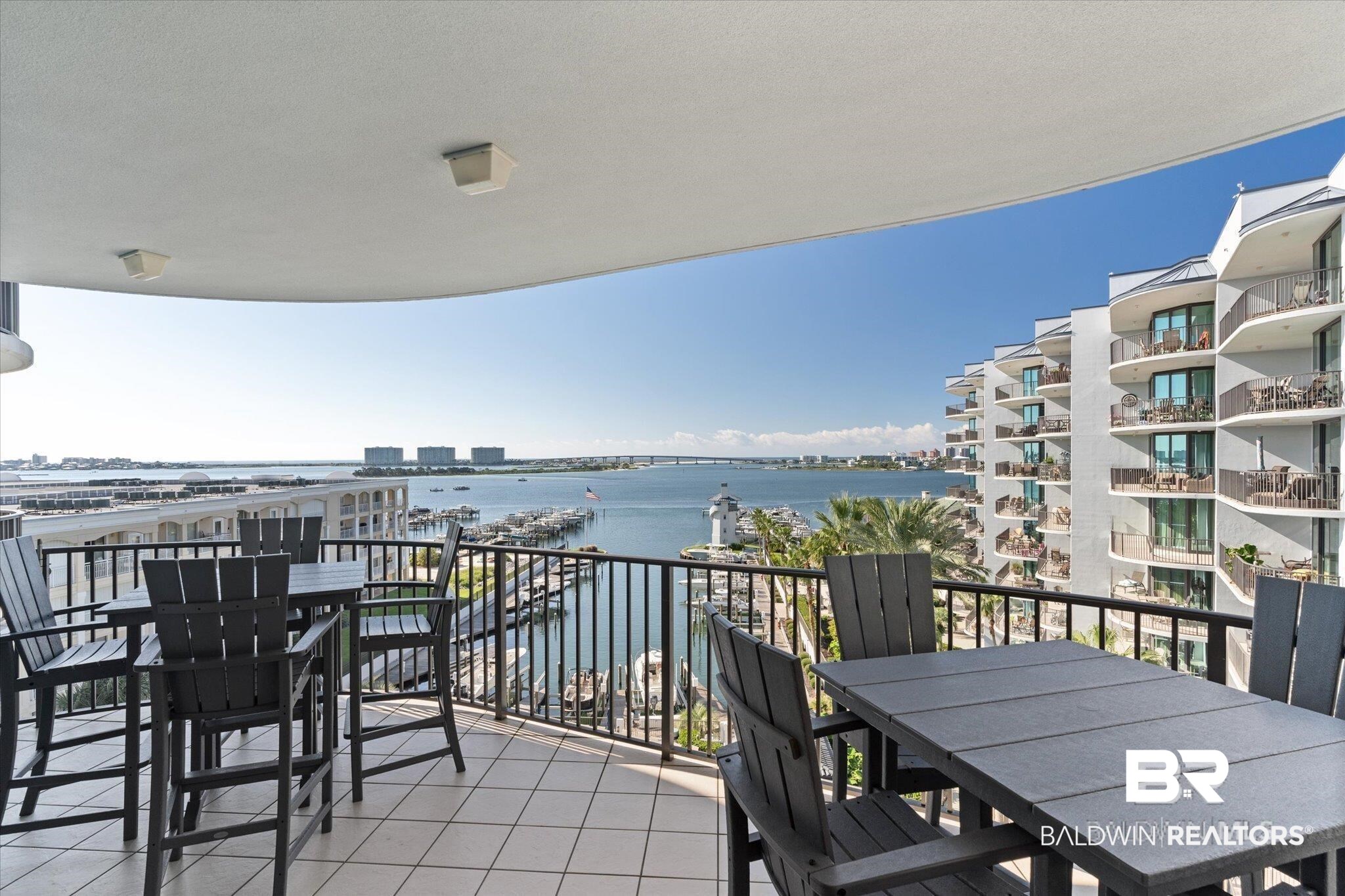 Balcony with outdoor dining area and a water view