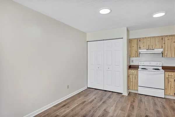 a room with a stove and a refrigerator
