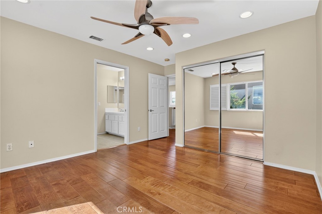 20543 Pesaro Porter Ranch Porter Ranch, CA 91326 - Photo 48 of 67 a view of an empty room with wooden floor and a ceiling fan