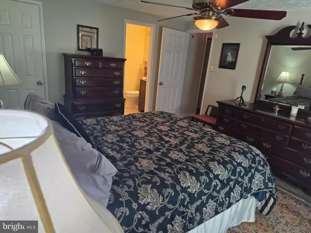a bedroom with a bed and a dresser