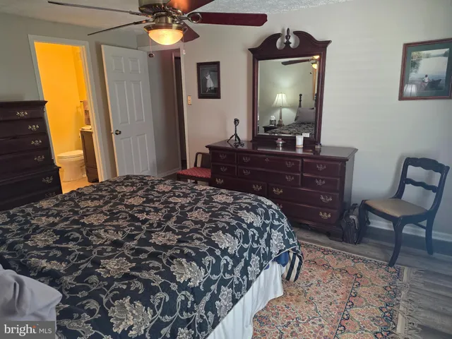 a bedroom with a bed and a mirror