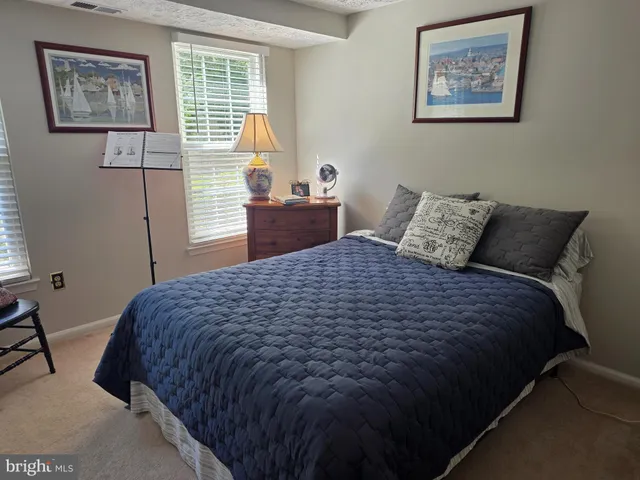 a bedroom with bed and wall painting