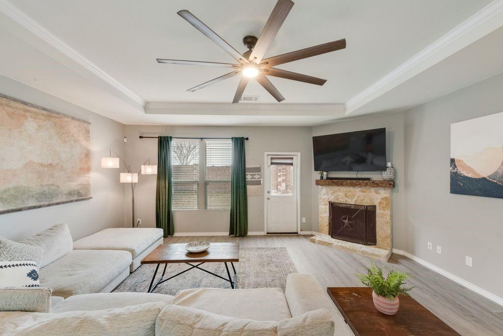 313 Citrus Drive Fate, TX 75189 - Photo 5 of 12 a living room with furniture a fireplace and a flat screen tv