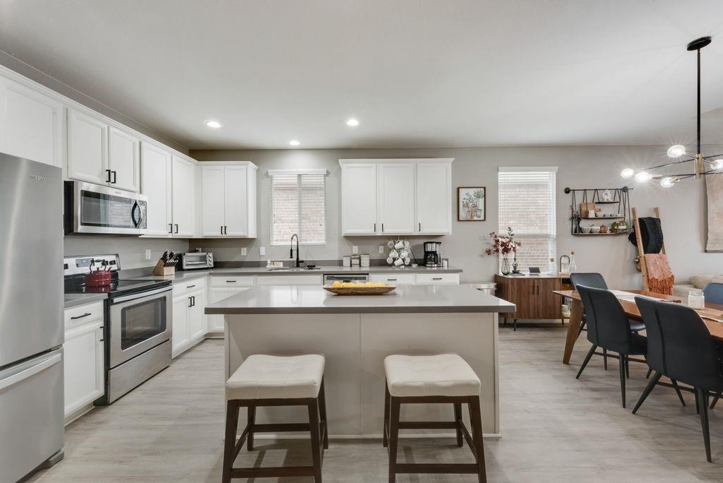 313 Citrus Drive Fate, TX 75189 - Photo 6 of 12 a kitchen with appliances a sink a counter top space and cabinets