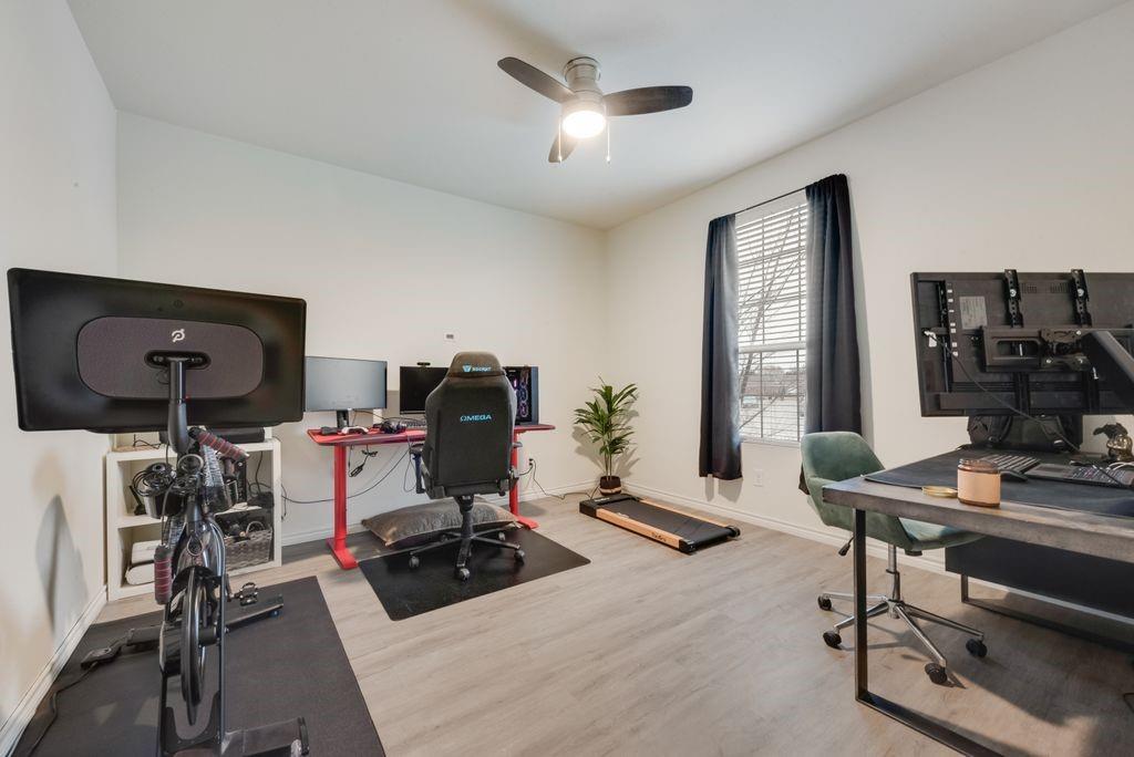 313 Citrus Drive Fate, TX 75189 - Photo 9 of 12 a room with gym equipment and a large window