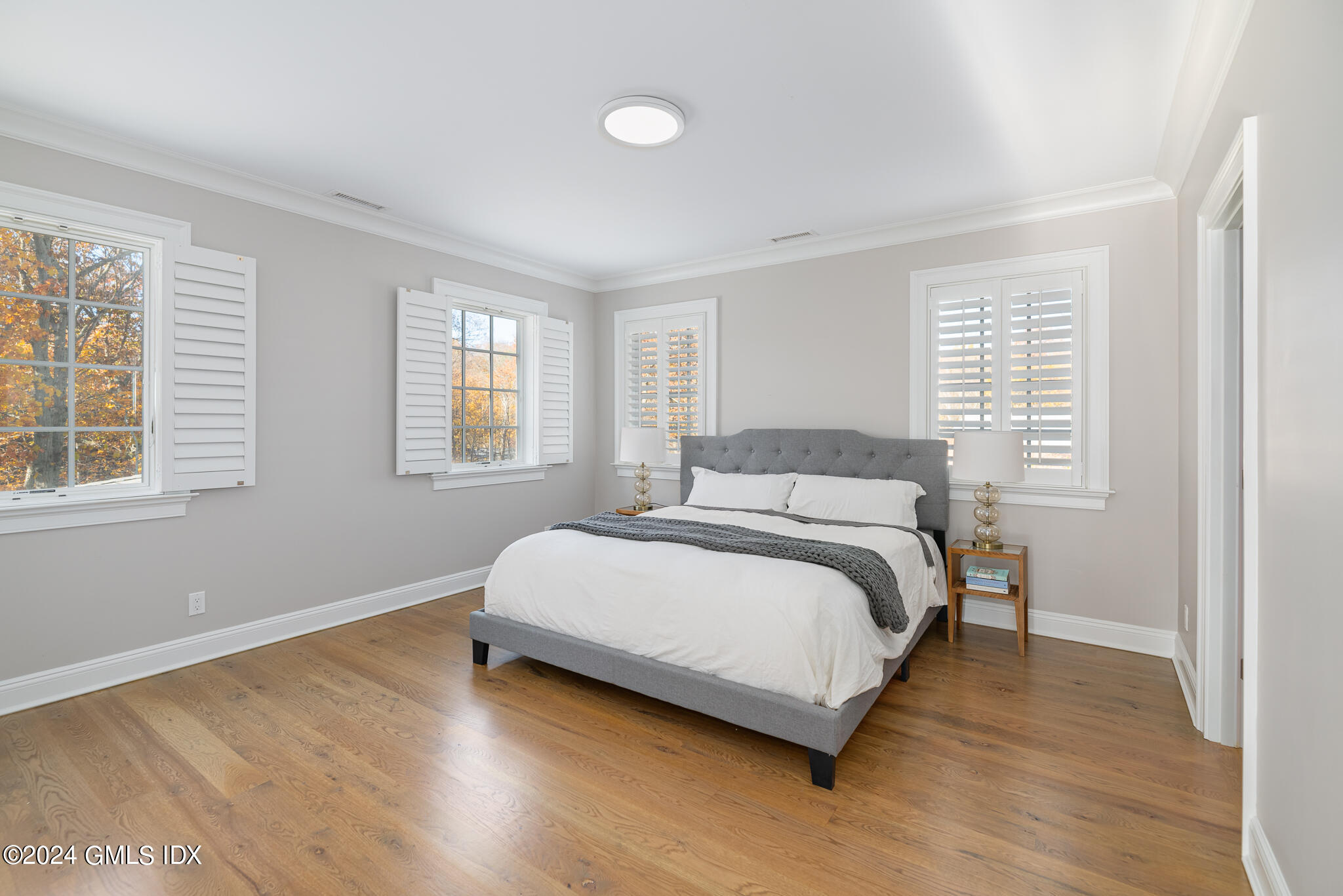 550 River Road Cos Cob, CT 06807 - Photo 14 of 32 a bedroom with a bed and wooden floor