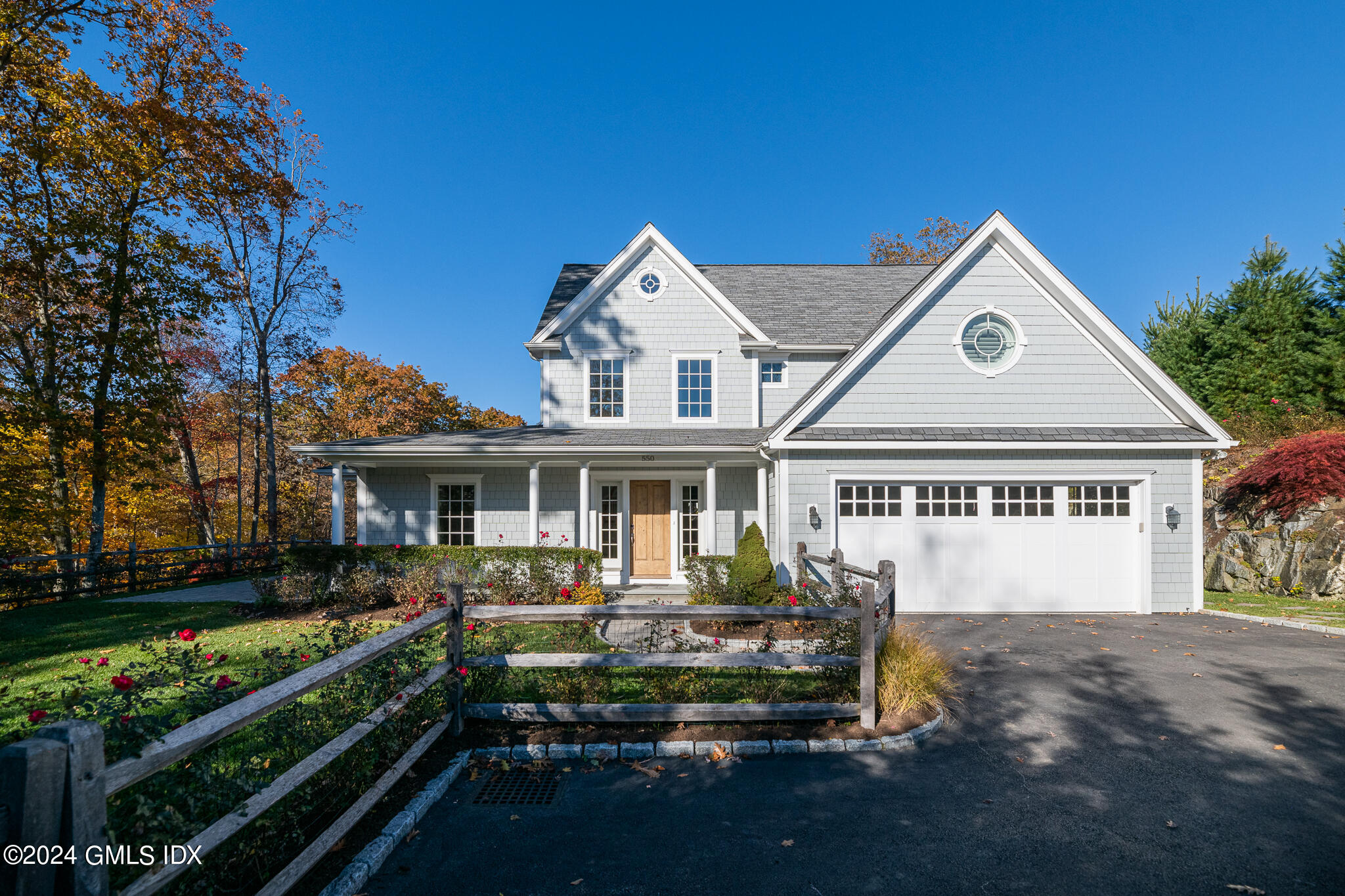 550 River Road Cos Cob, CT 06807 - Photo 2 of 32 a front view of a house with a yard