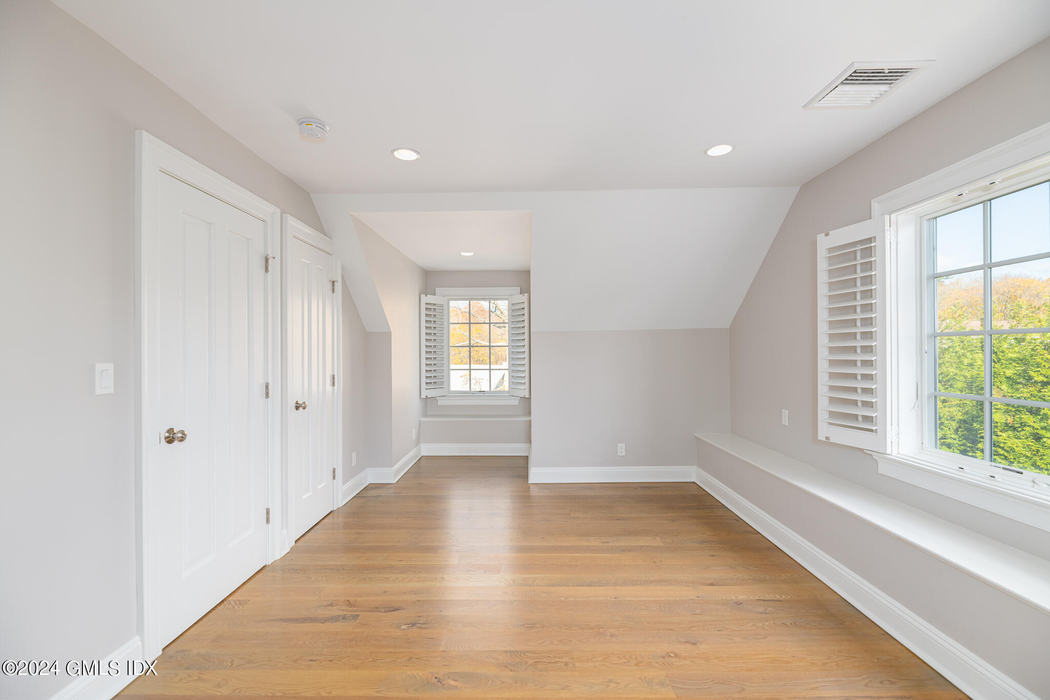 550 River Road Cos Cob, CT 06807 - Photo 22 of 32 a view of an empty room with wooden floor and a window