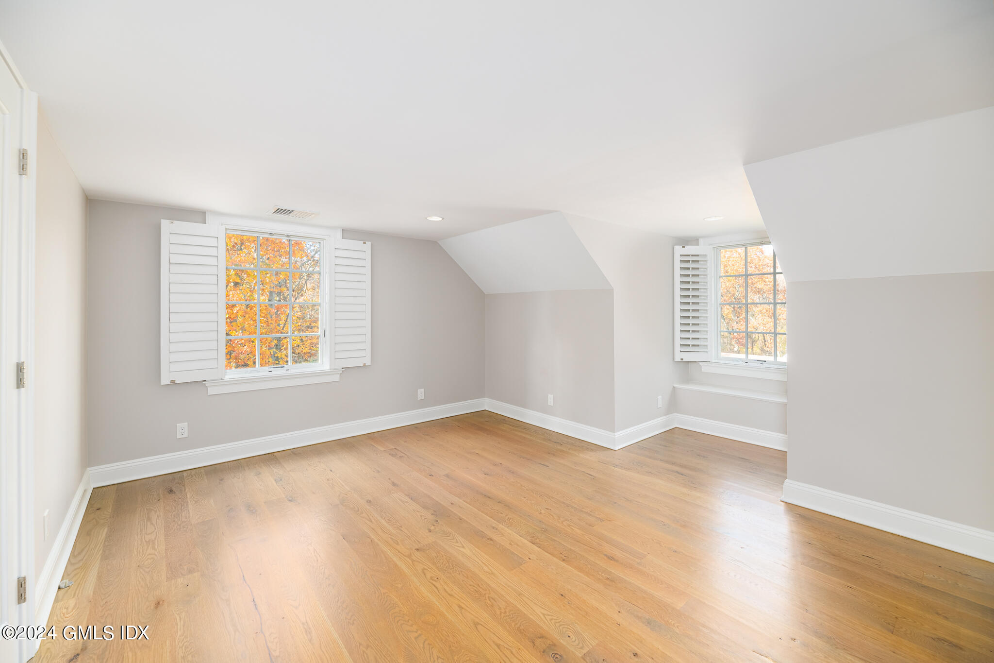 550 River Road Cos Cob, CT 06807 - Photo 24 of 32 an empty room with wooden floor and windows