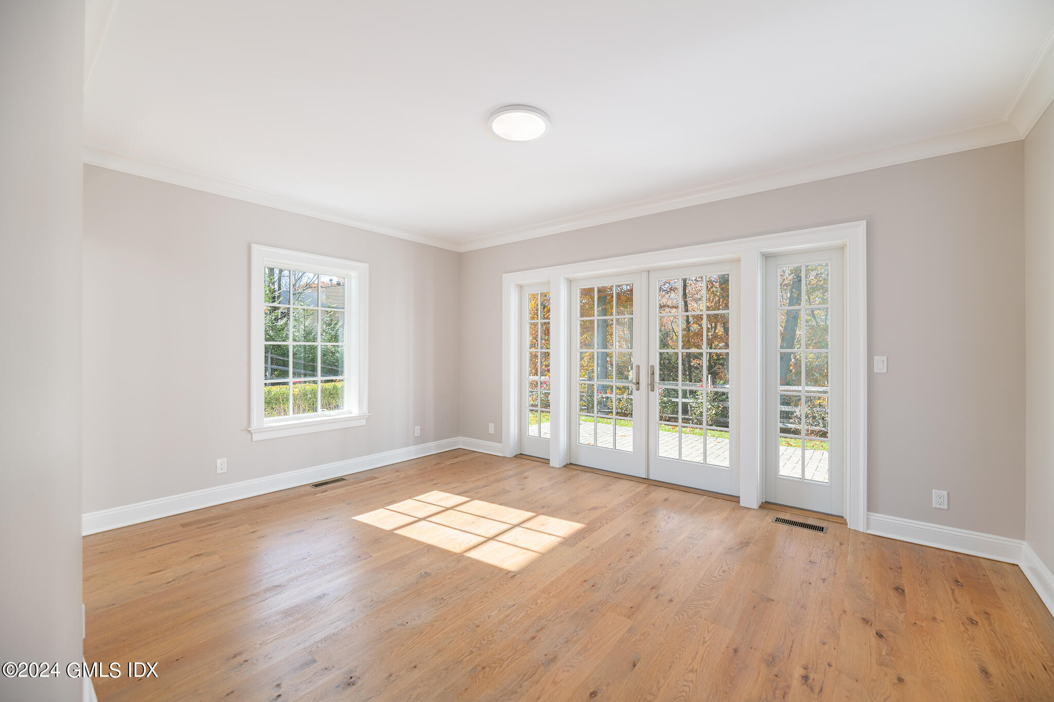 550 River Road Cos Cob, CT 06807 - Photo 6 of 32 an empty room with wooden floor and windows