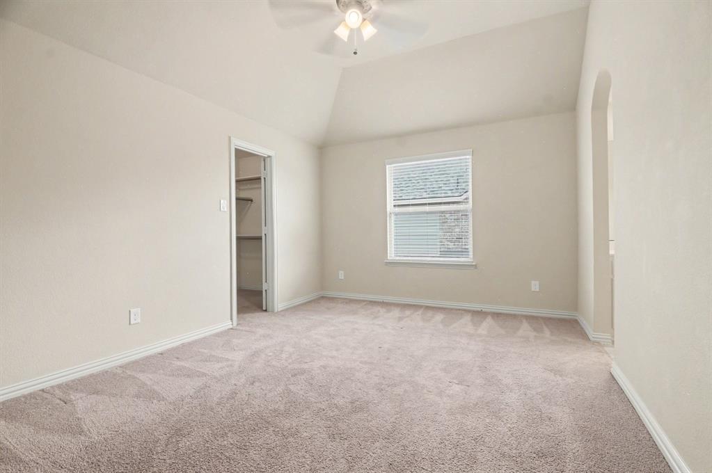 708 Yarrow Street Little Elm, TX 75068 - Photo 16 of 26 an empty room with chandelier fan and windows