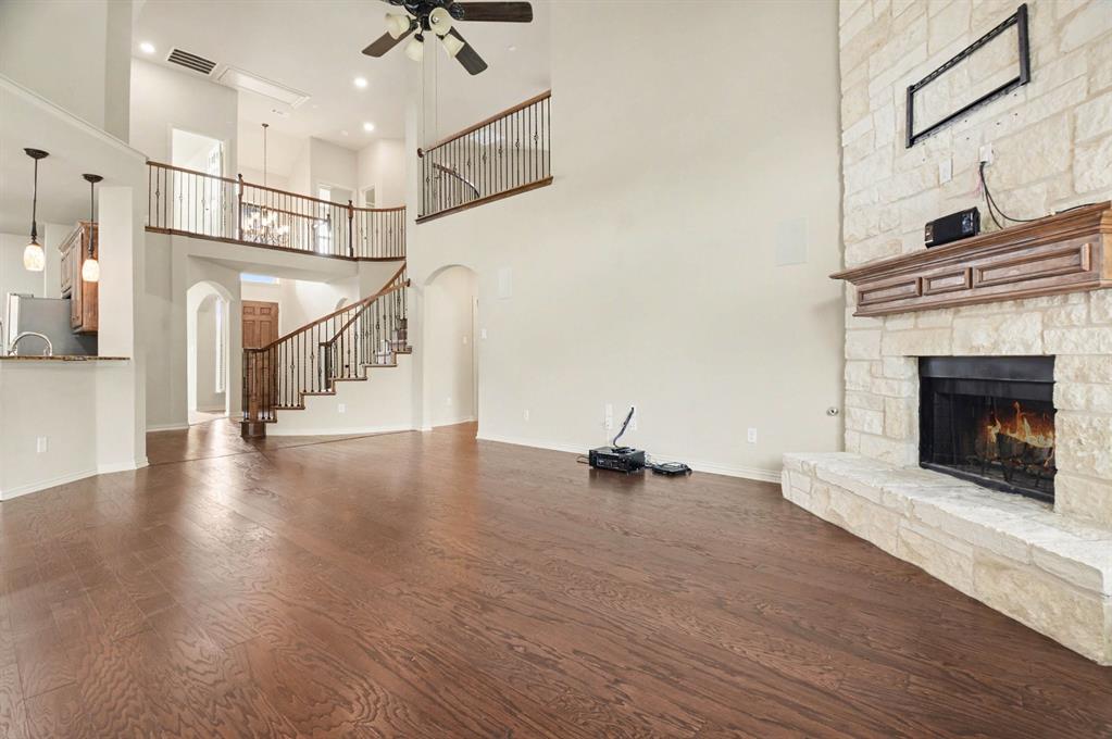 708 Yarrow Street Little Elm, TX 75068 - Photo 2 of 26 a view of a livingroom with a fireplace and wooden floor