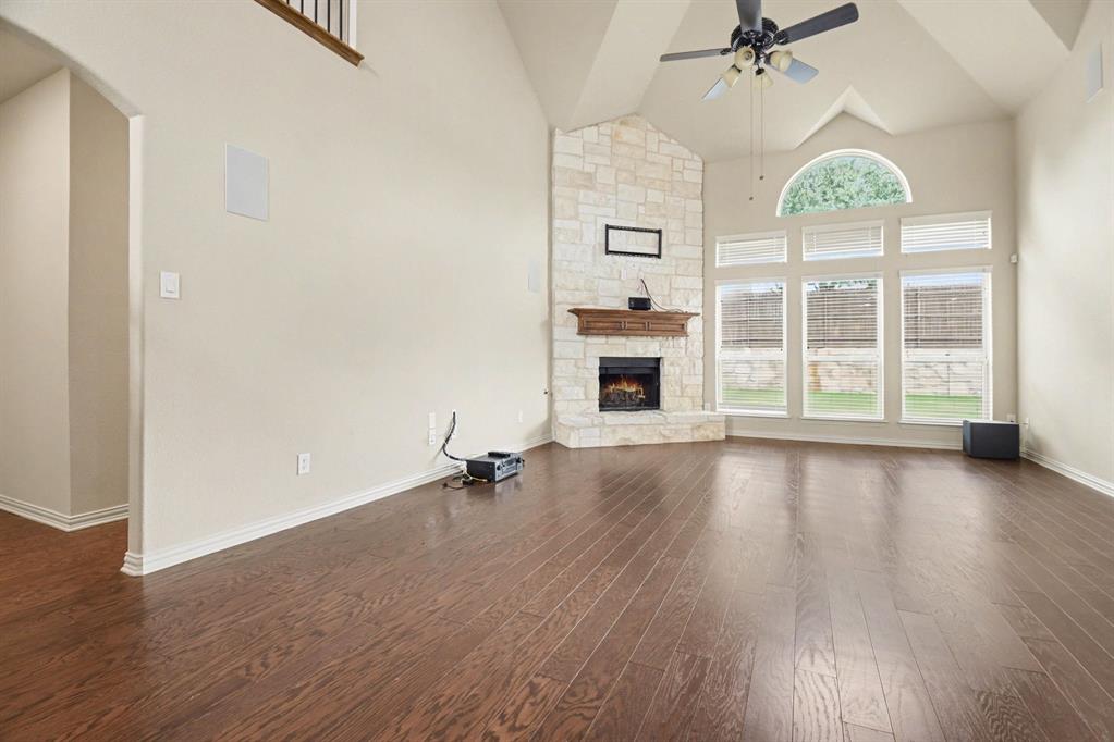 708 Yarrow Street Little Elm, TX 75068 - Photo 6 of 26 wooden floor in an empty room with a fireplace