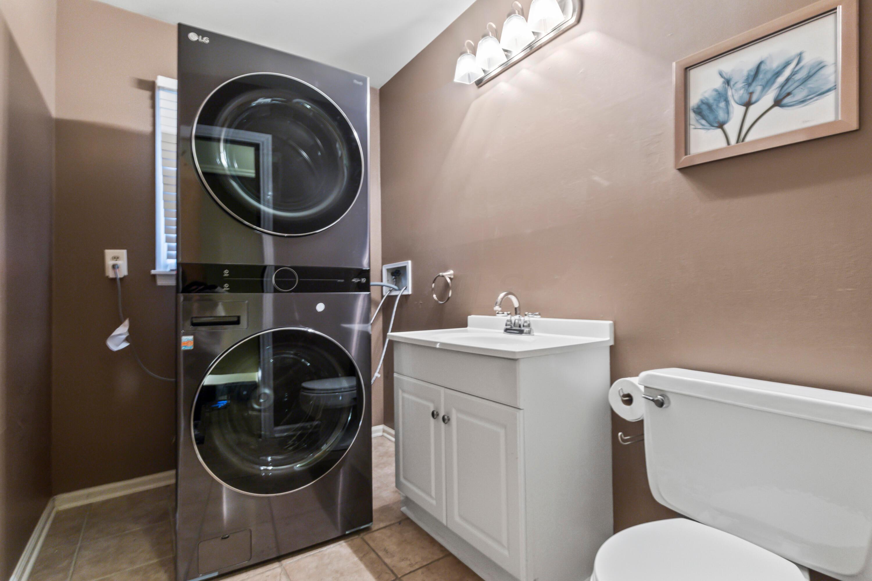 7020 Rieber Street Columbus, OH 43085 - Photo 20 of 40 • New ceramic tile flooring • Taupe painted walls • Washer & dryer do not remain • Electric dryer hookup • Enclosed vanity with single bowl, cultured marble sinktop • Four-bulb wall light • 2” blinds